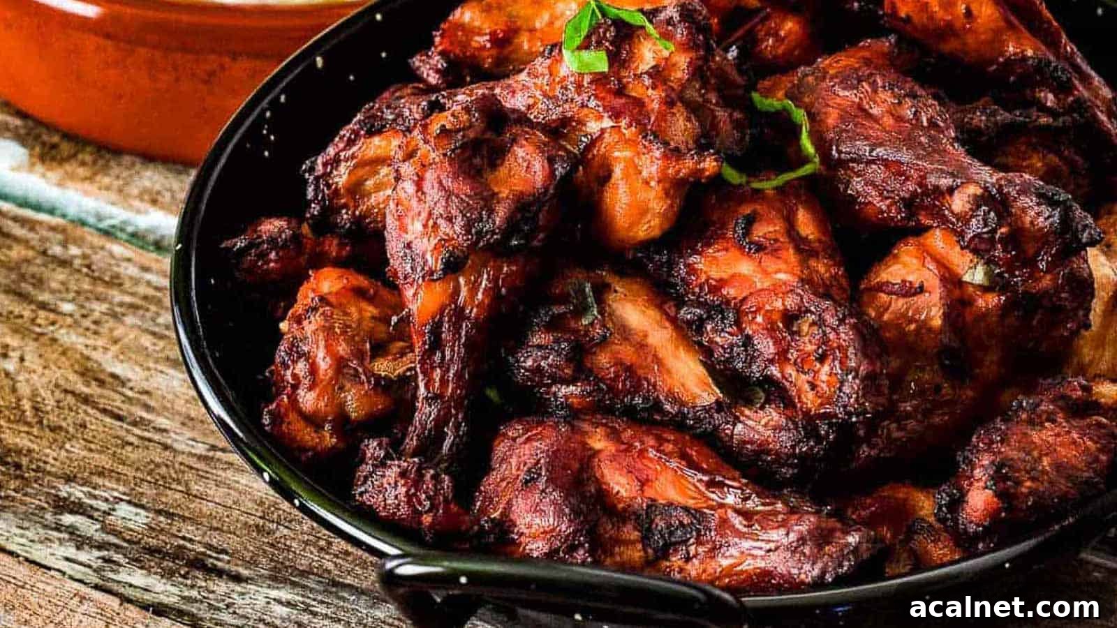 29 Chicken Dinners That Keep Coming Back to Our Weekly Menu 2 A plate of tandoori chicken with a side dish of cooked rice, shot from a low angle.