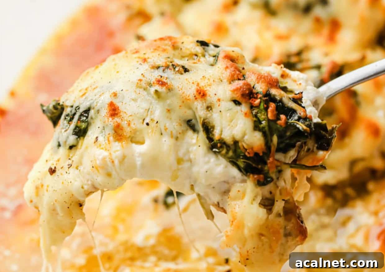 29 Chicken Dinners That Keep Coming Back to Our Weekly Menu 25 A serving spoon serving of creamy spinach chicken bake.