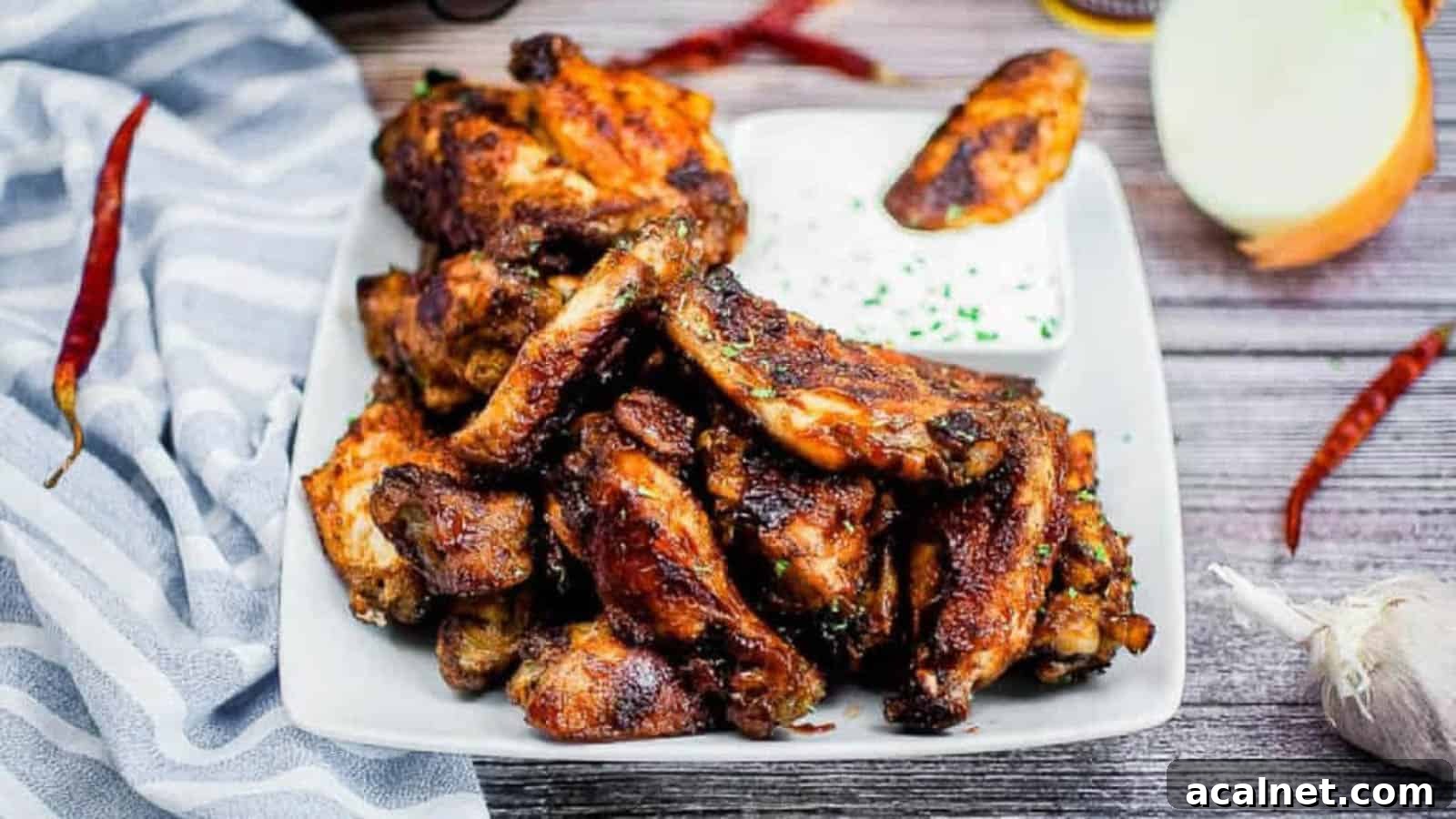 29 Chicken Dinners That Keep Coming Back to Our Weekly Menu 31 A pile of air fryer BBQ wings on a white platter.