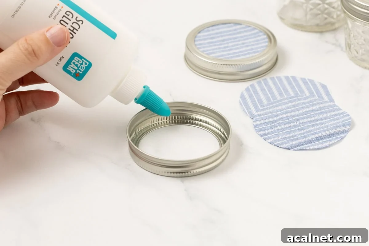fabric circles being glued onto a mason jar ring