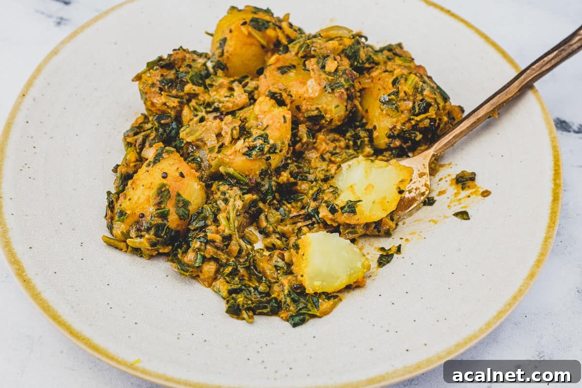 Saag aloo curry (Spinach & Potato) on a plate with a spoon