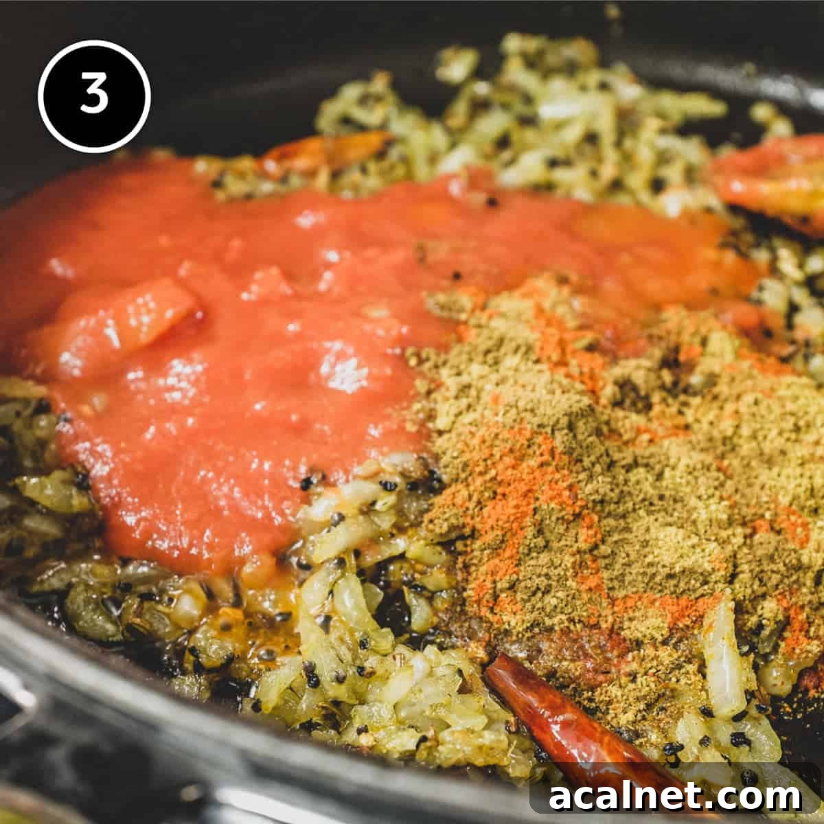 Adding spices and tomato to a pan for Saag Aloo (Spinach & Potato curry)