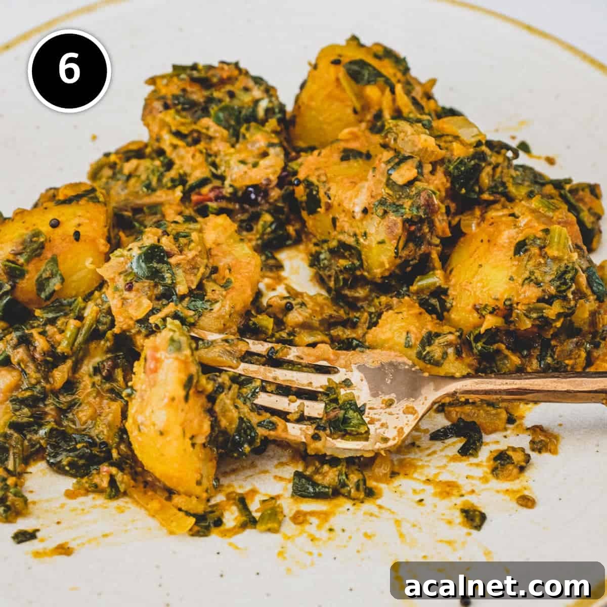 Serving Saag Aloo (Spinach & Potato curry) on a plate with a fork