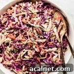 Coleslaw in a white serving bowl.