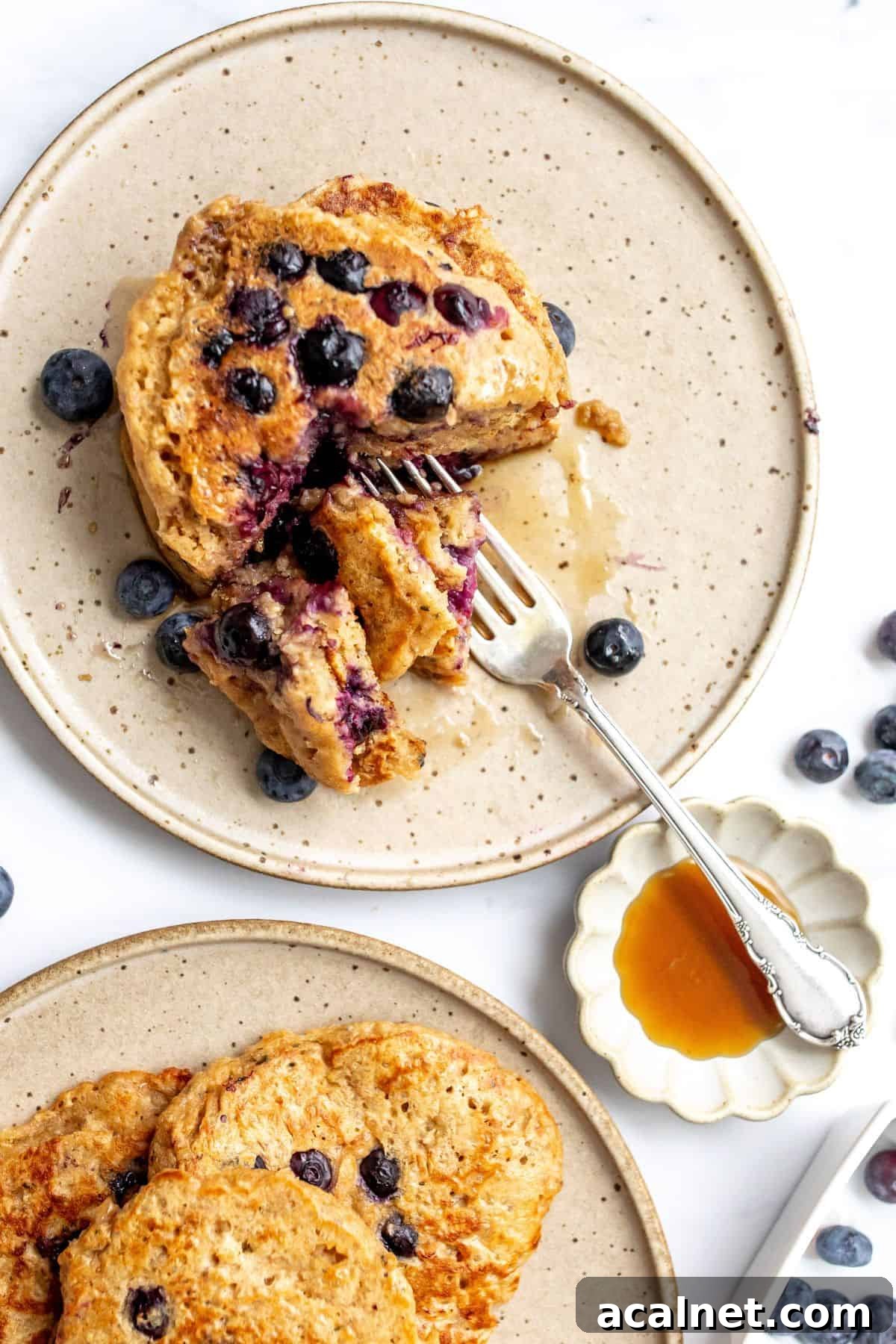 healthy whole wheat pancakes with berries and a silver fork. 