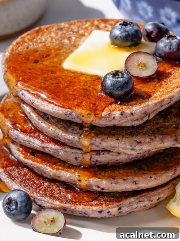 Protein Pancakes on a white plate with blueberries and cottager cheese.
