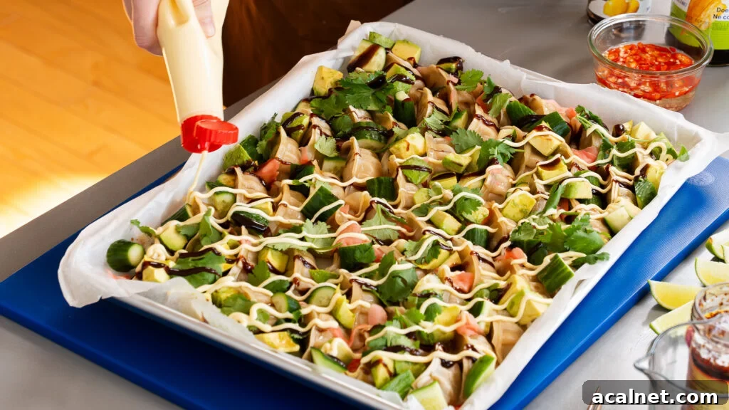 Adding kewpie mayo to sheet pan dumplings.