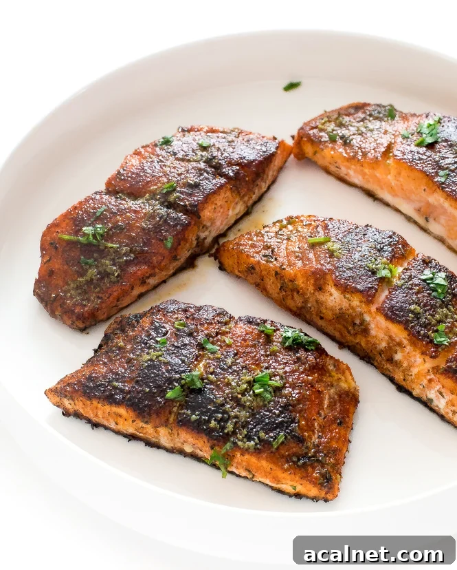 Blackened Salmon | chefsavvy.com Blackened Salmon with fresh parsley on white plate