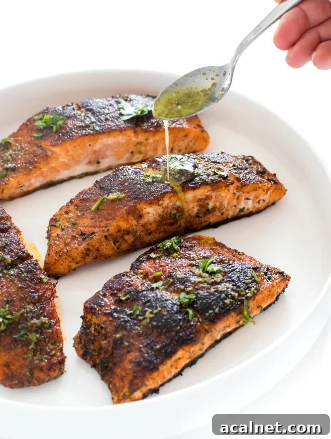 Topping salmon with lime butter sauce | chefsavvy.com drizzling salmon with lime butter sauce