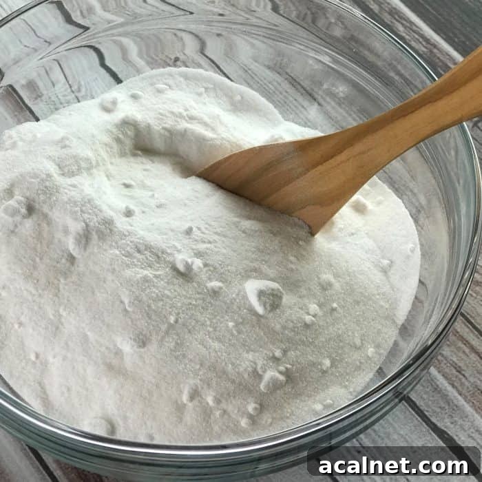 baking soda and citric acid mixed together in glass bowl to make essential oil tea tree facial steamer tabs