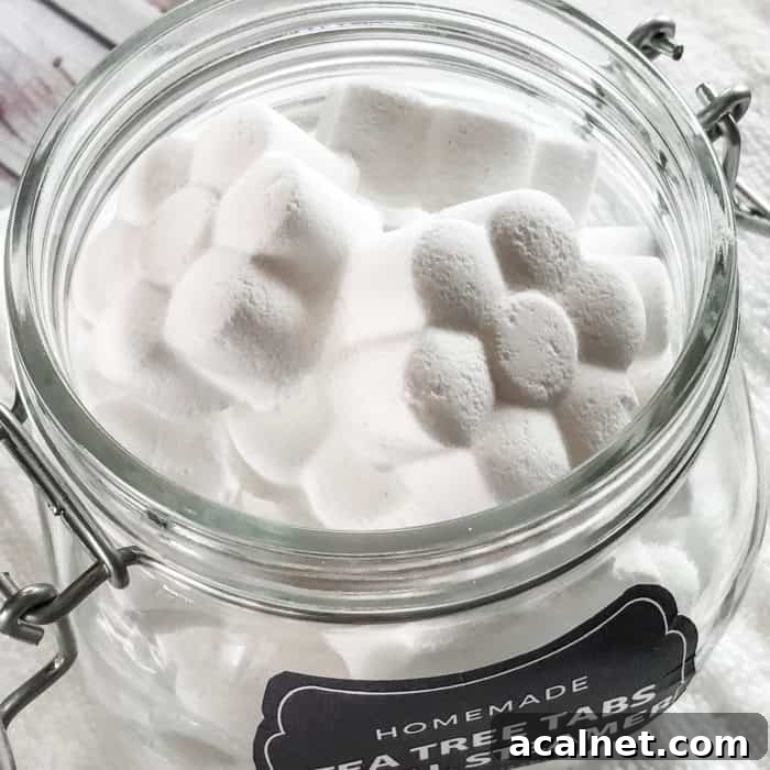 flower shaped tea tree essential oil facial steamer tabs in open glass jar with custom label
