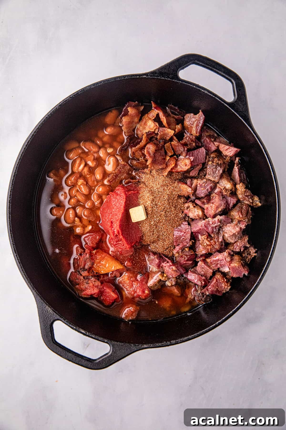 Adding Smoked Brisket Chili ingredient to cooking pot