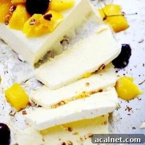 Four slices of mango semifreddo with the remaining semifreddo beside them