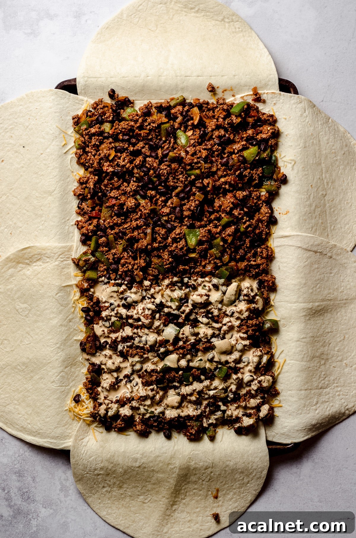 Sheet Pan Quesadillas: Quick Oven-Baked Mexican Dinner 12 Adding sauce to half of pan of quesadillas.
