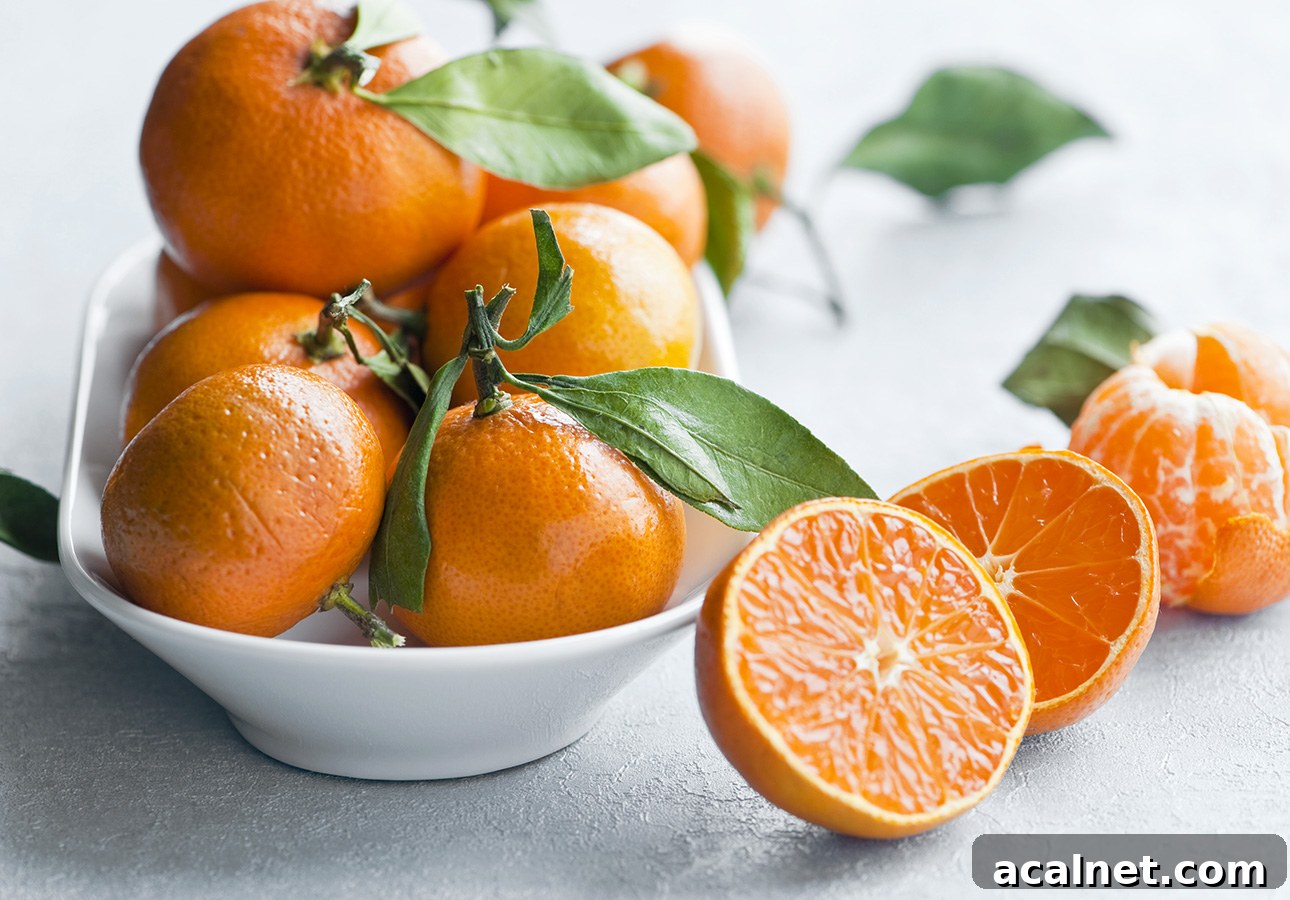 A bowl of tangerine oranges with one fruit cut open