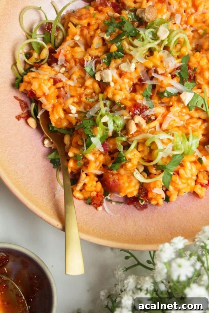 Gochujang Cheesy Risotto with Creamy Korean Chili Flavor 11 Close up of gochujang risotto in a pink bowl.