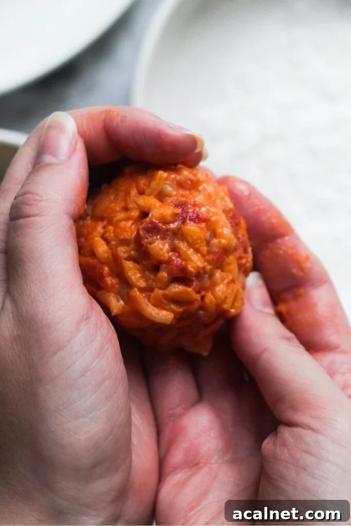 Gochujang Cheesy Risotto with Creamy Korean Chili Flavor 13 2 hands forming arancini rice ball.