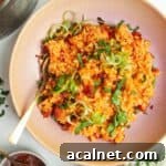 Gochujang risotto topped with scallions with sweet chilli jam on the side.