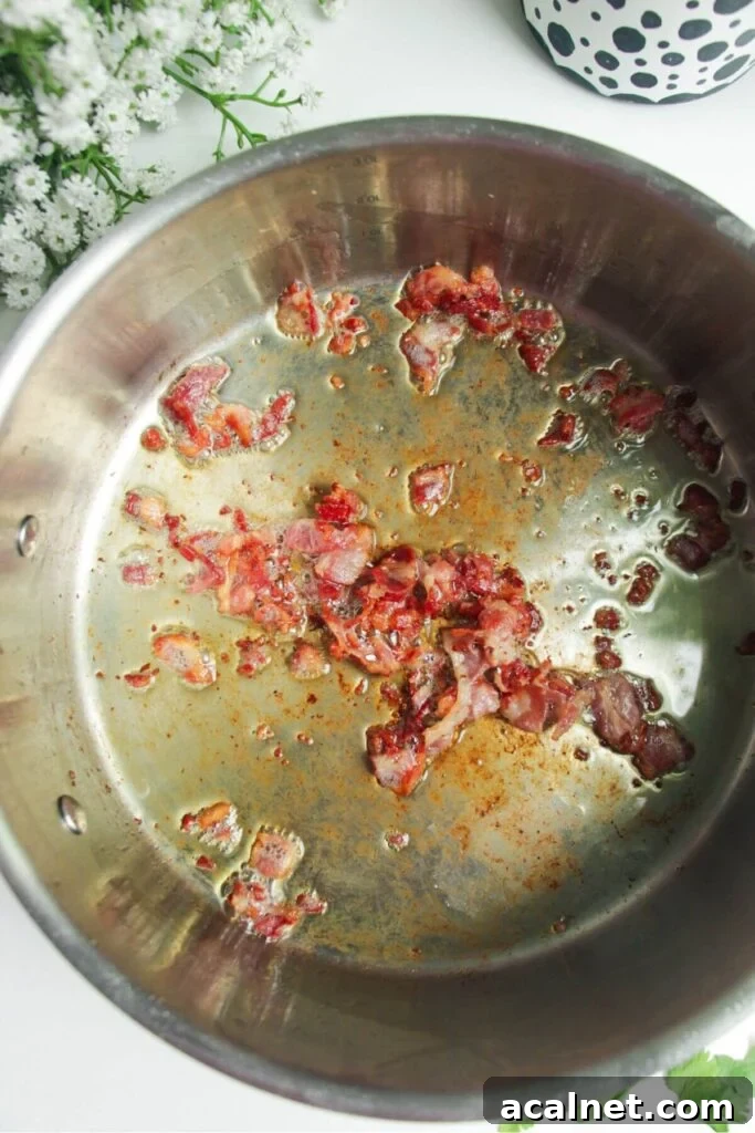 Gochujang Cheesy Risotto with Creamy Korean Chili Flavor 4 Bacon cooking in a large pan.