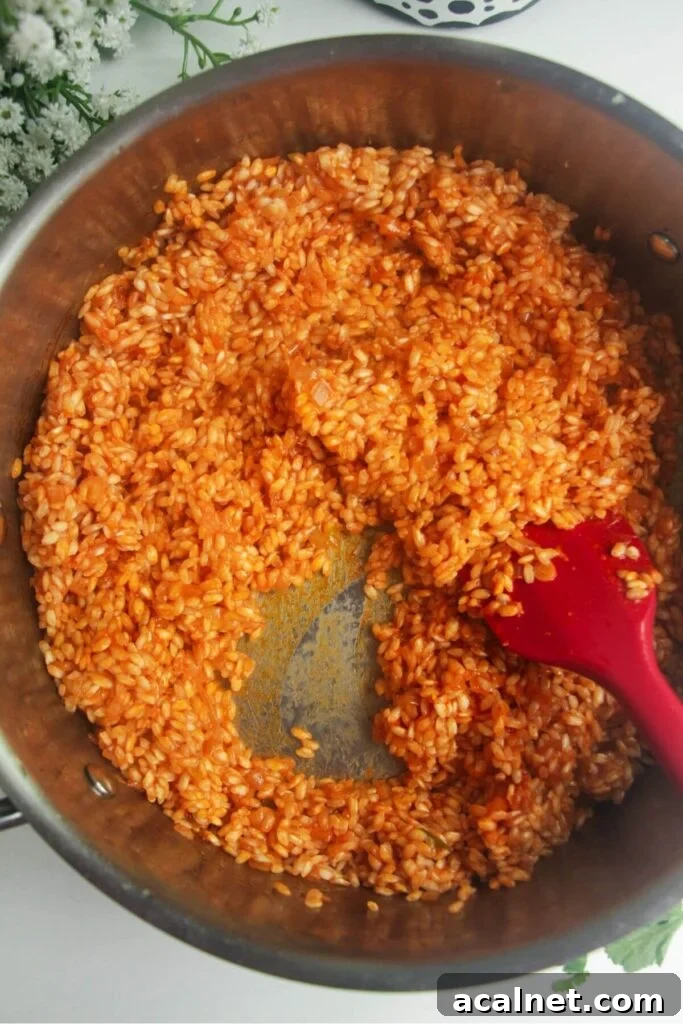 Gochujang Cheesy Risotto with Creamy Korean Chili Flavor 8 Wine added to a large pan with risotto in it.