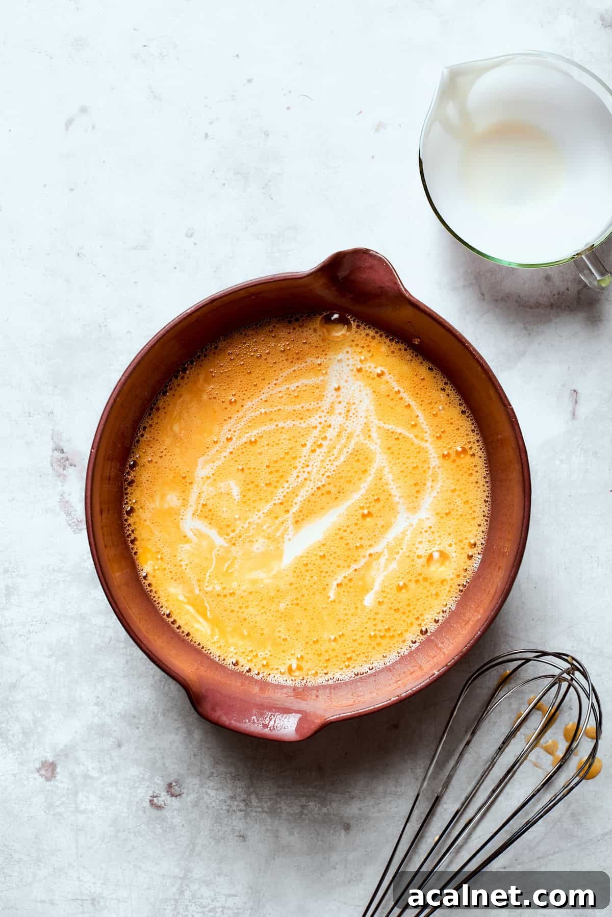 Whisk eggs and cream Eggs whisked with cream in a bowl.