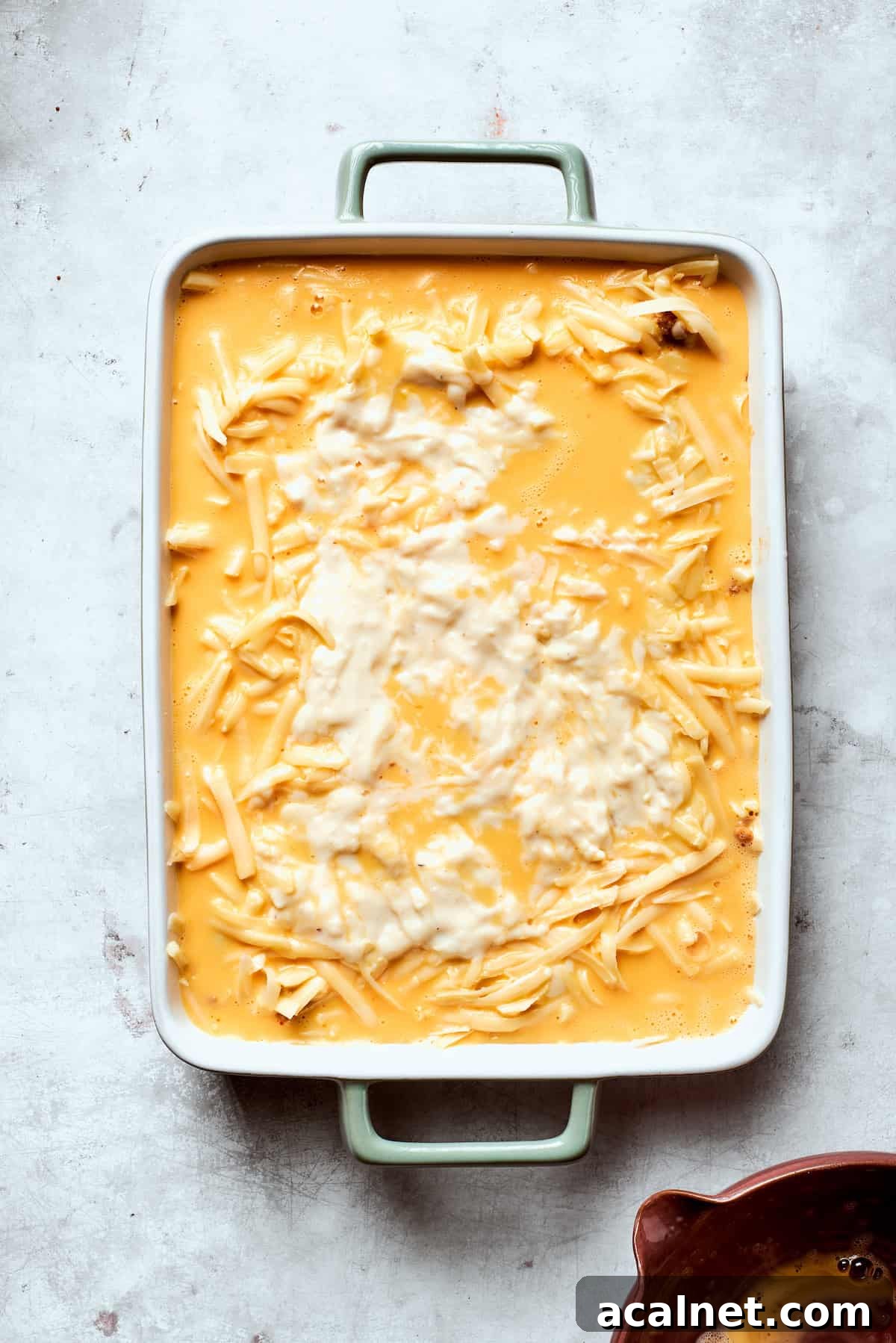 Add eggs Eggs are poured into a pan of biscuits and gravy casserole.