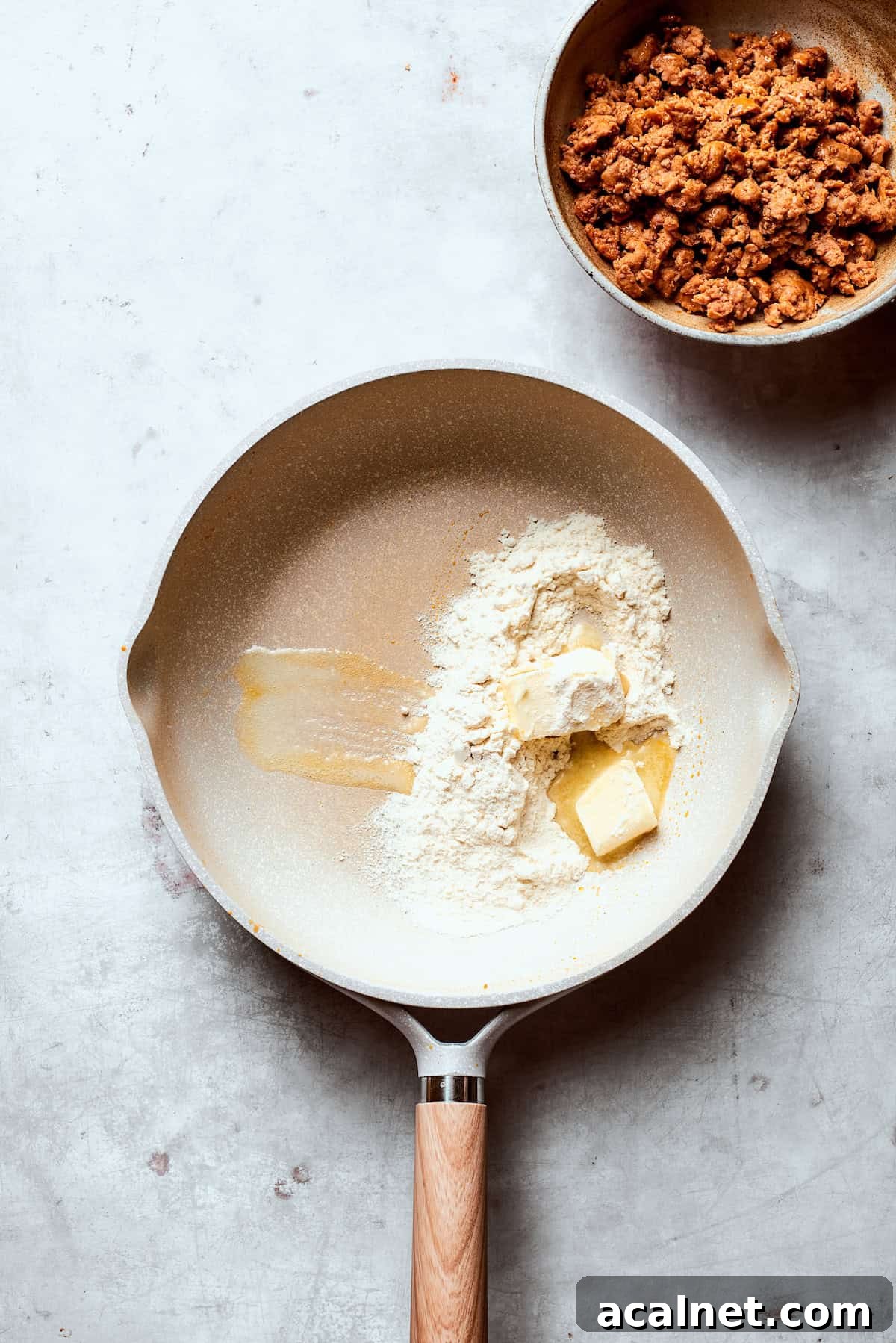 Melt butter and add flour Butter and flour added to a skillet.