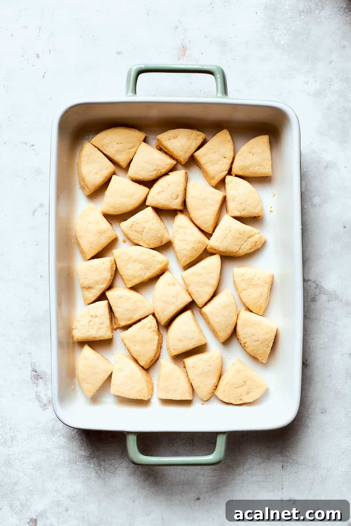 Arrange biscuit dough Pieces of biscuit dough in a baking pan.