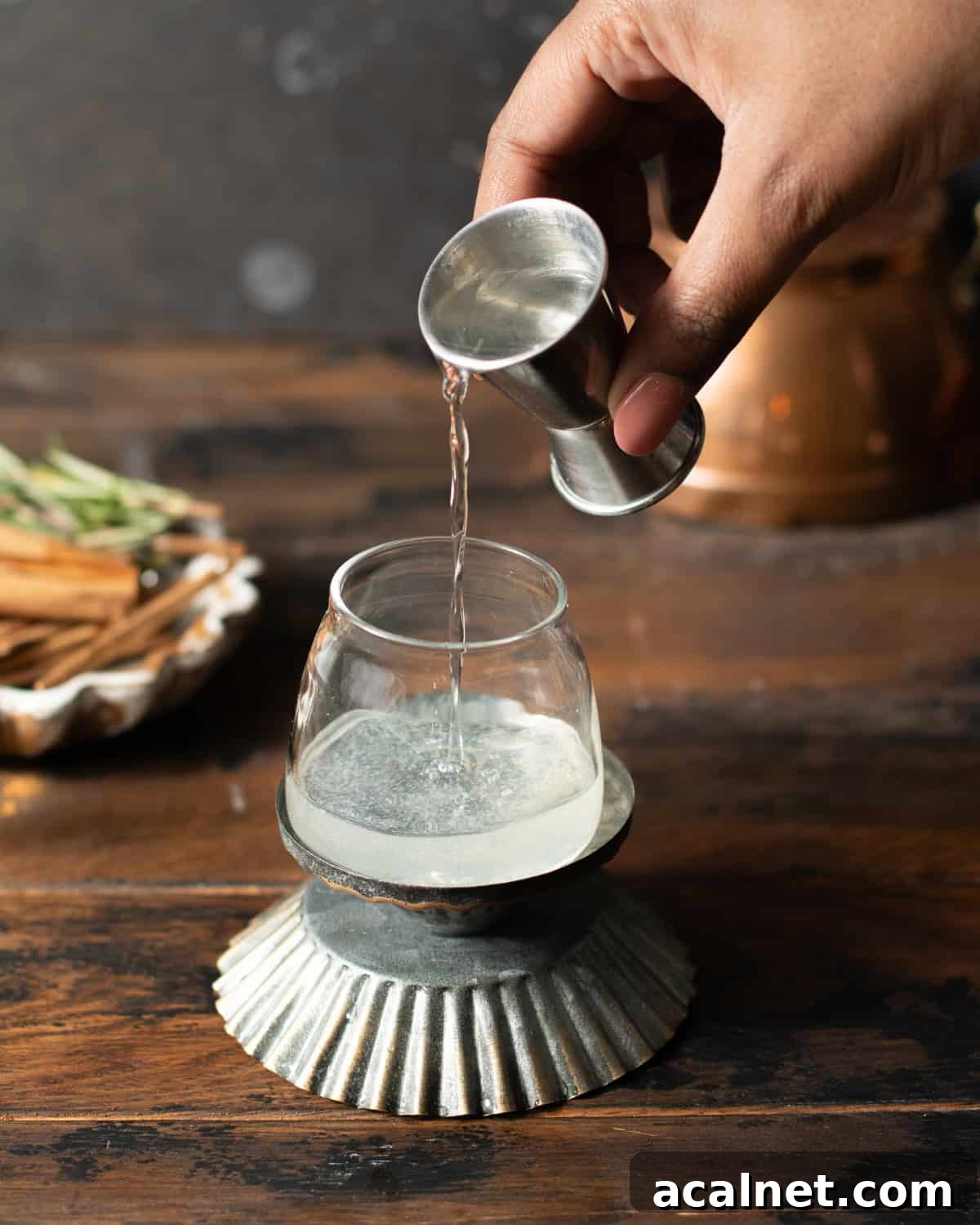 peach schnapps beings poured into a shot glass.