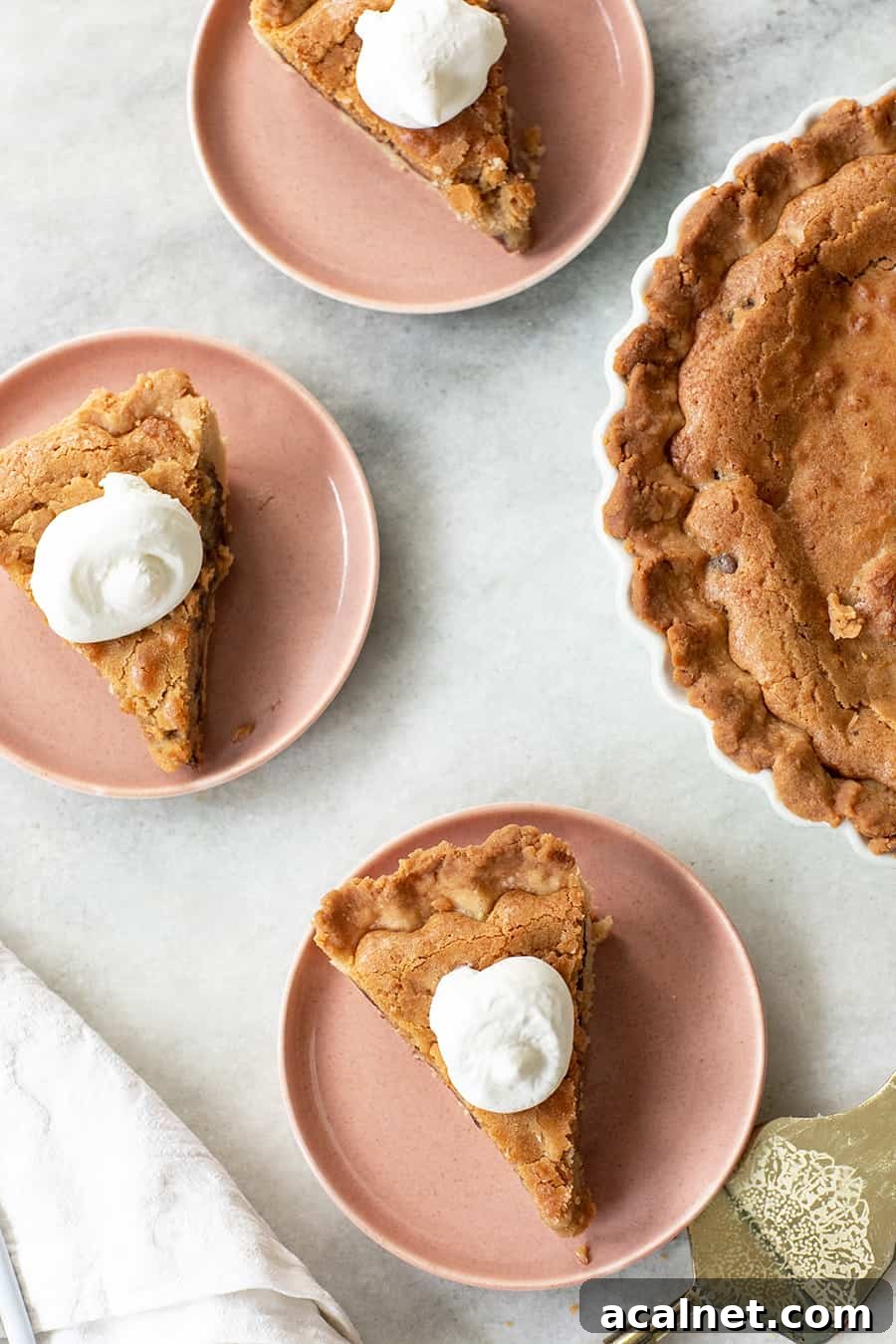 Chocolate chip cookie pie served with whipped cream.