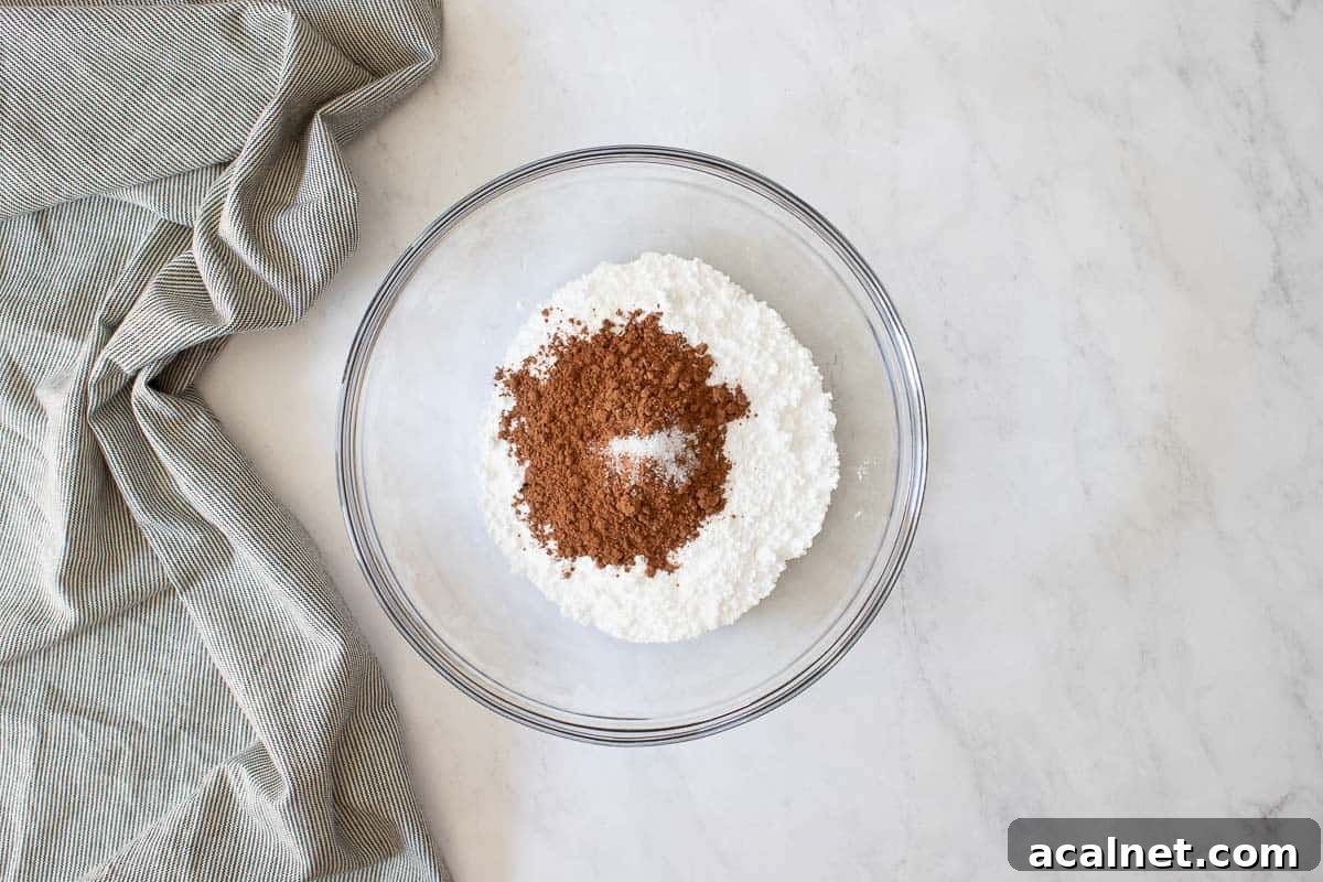Clear glass bowl with powdered sugar and cocoa powder.