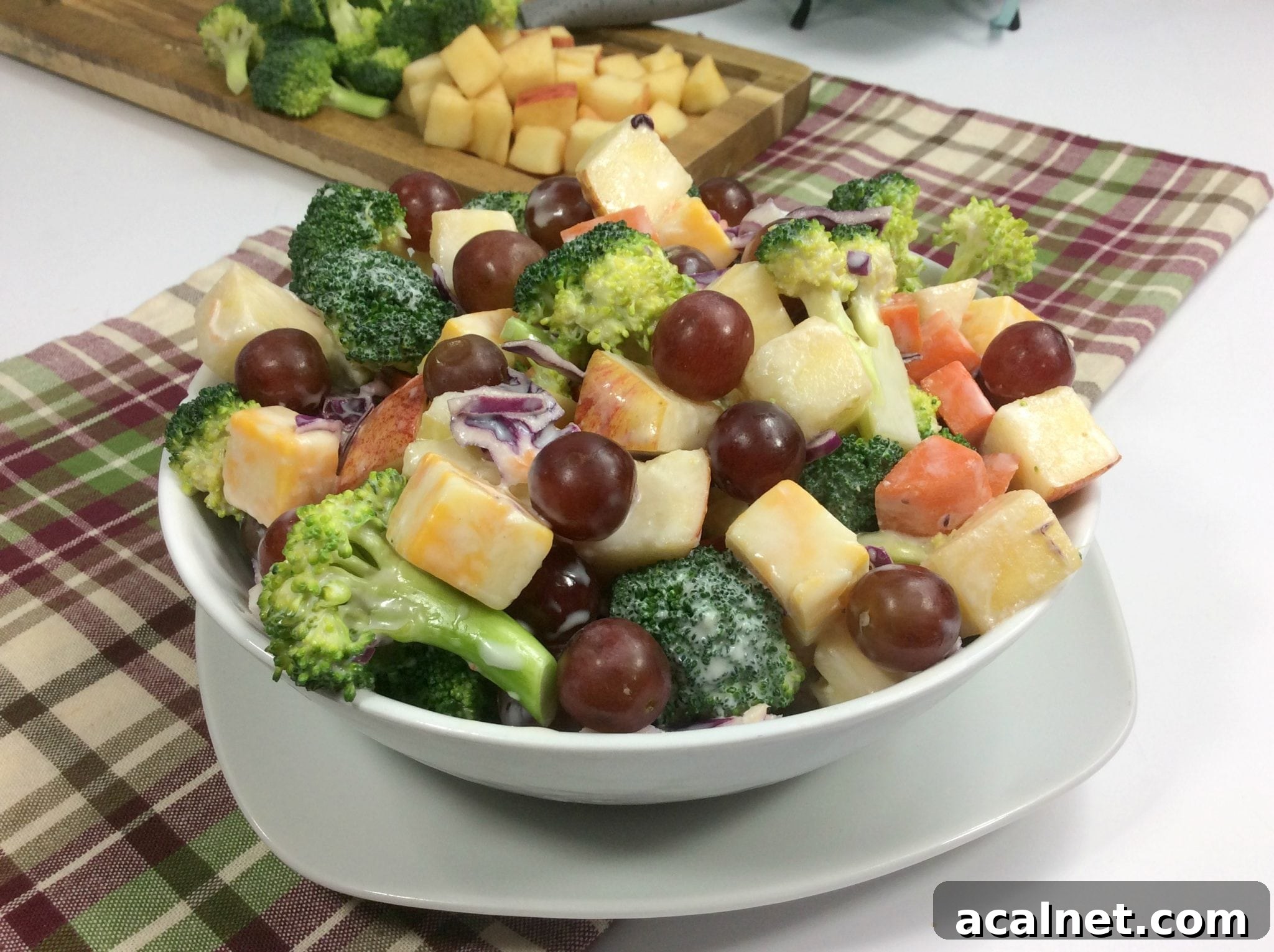 Weight Watchers broccoli salad in a white bowl on top of plaid towel