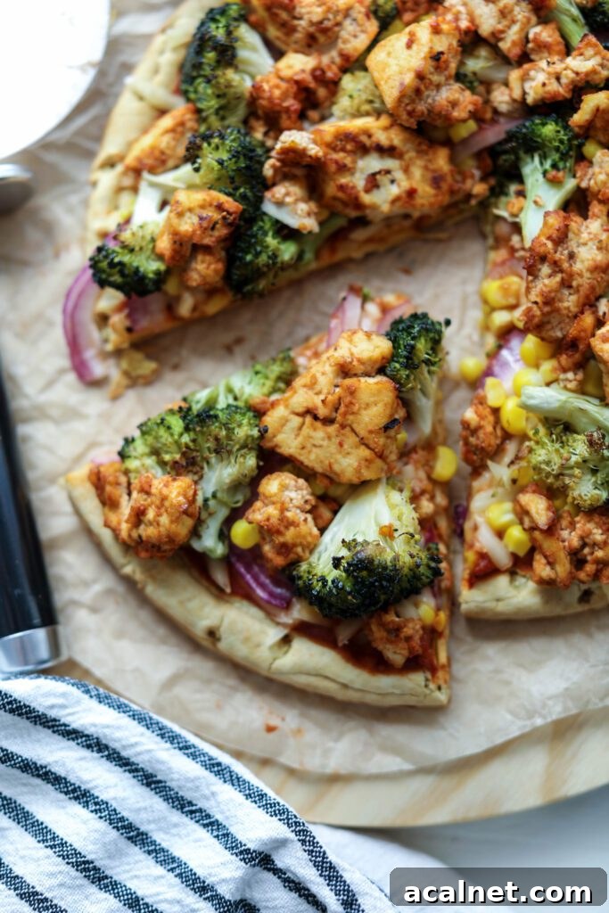 BBQ Tofu Pizza sliced on wooden board by Flora & Vino