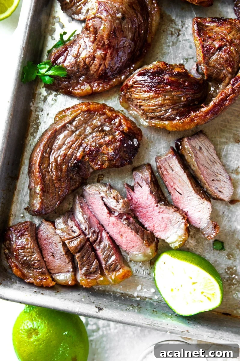 Air Fryer Picanha Steak Recipe: Perfect Crispy Crust & Juicy Center 13 Cooked picanha steak on skewers with limes and parsley.