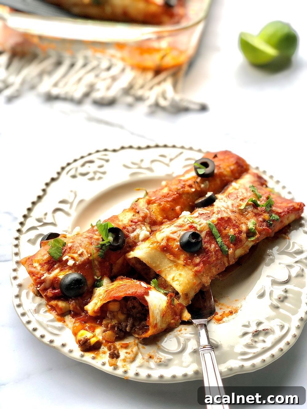 Stack of enchiladas topped with sauce and cheese