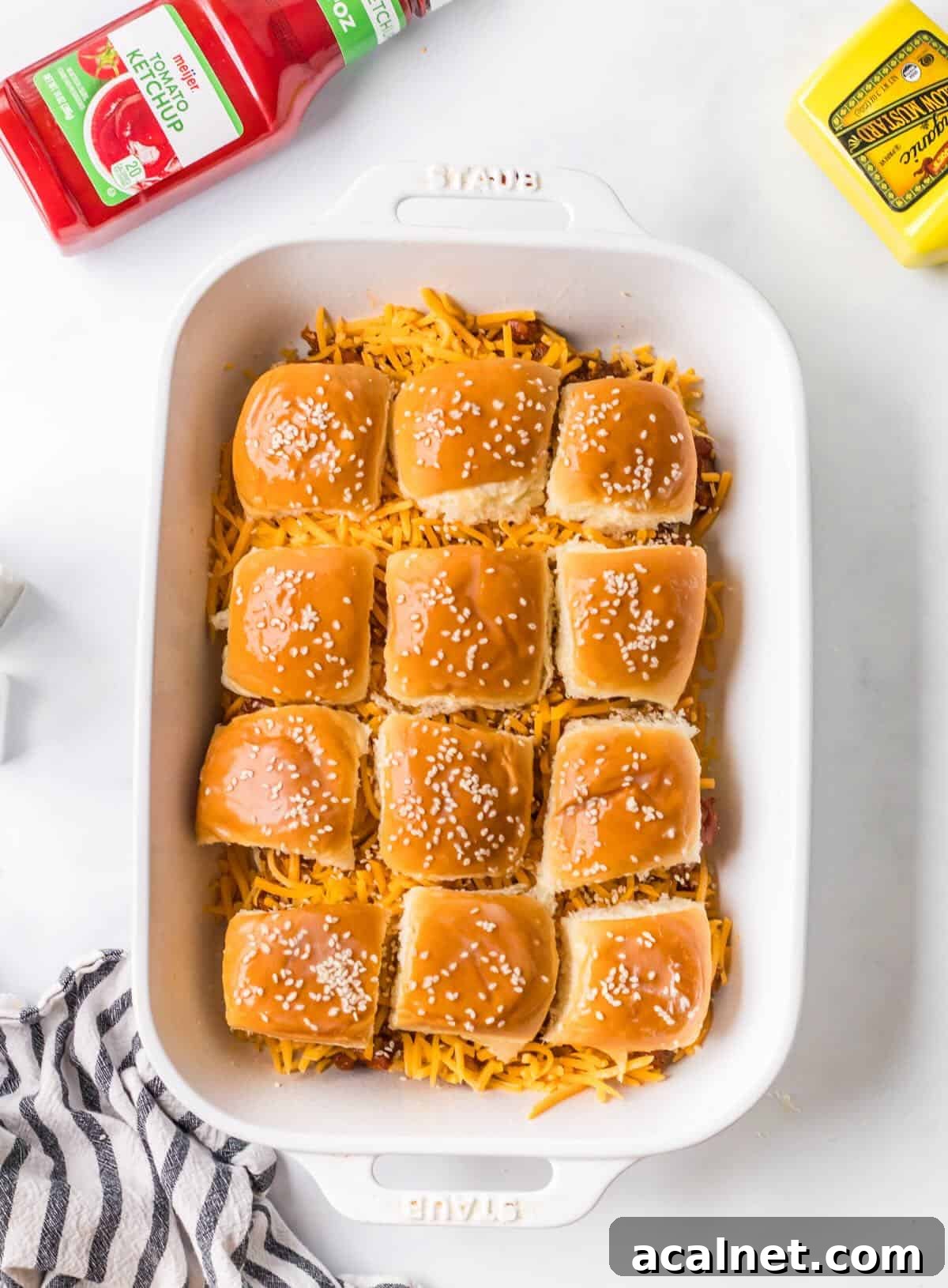 Ground beef sloppy joes on slider buns before baking.