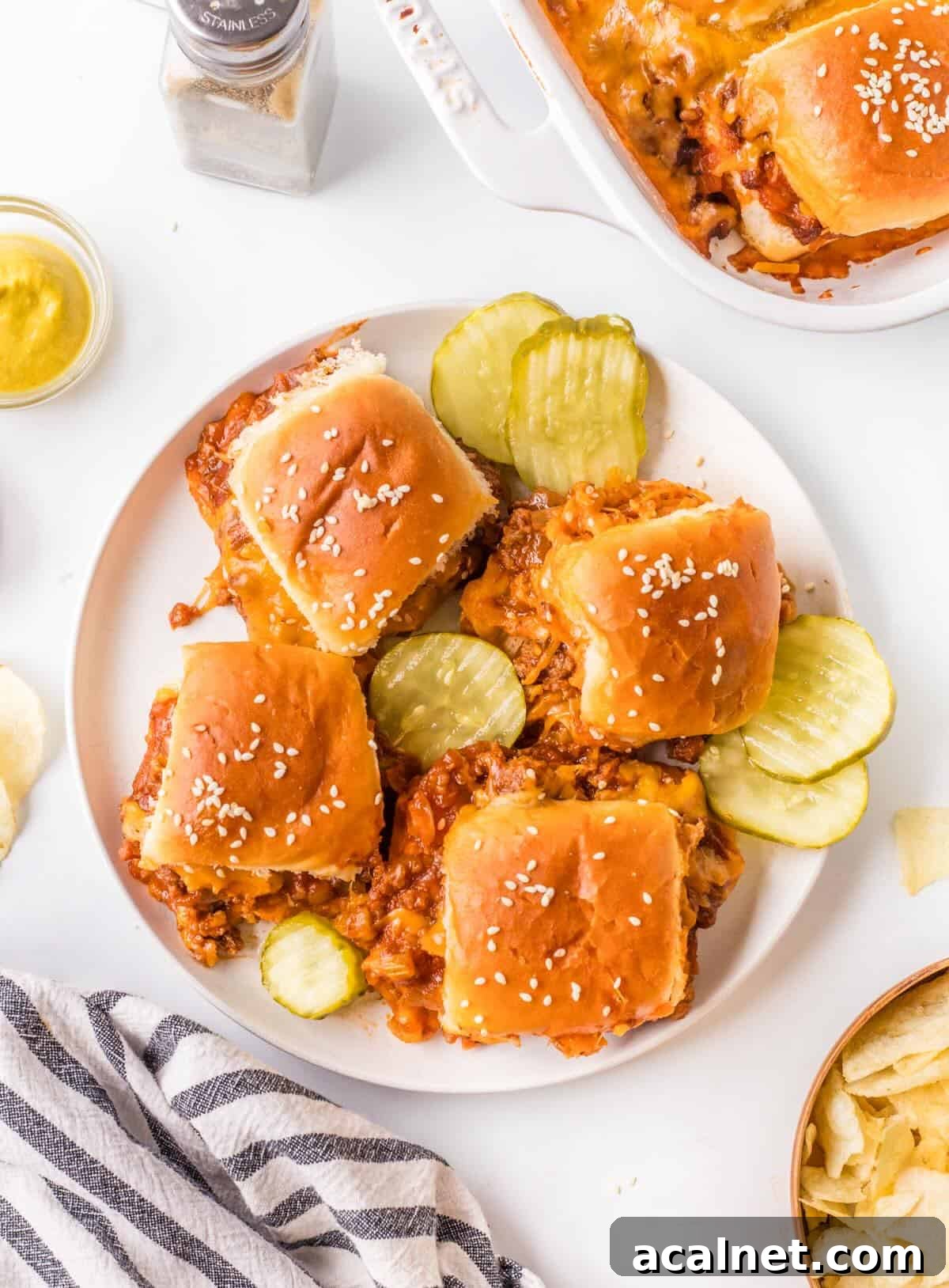 Plated sliders with potato chips and dill pickle chips.