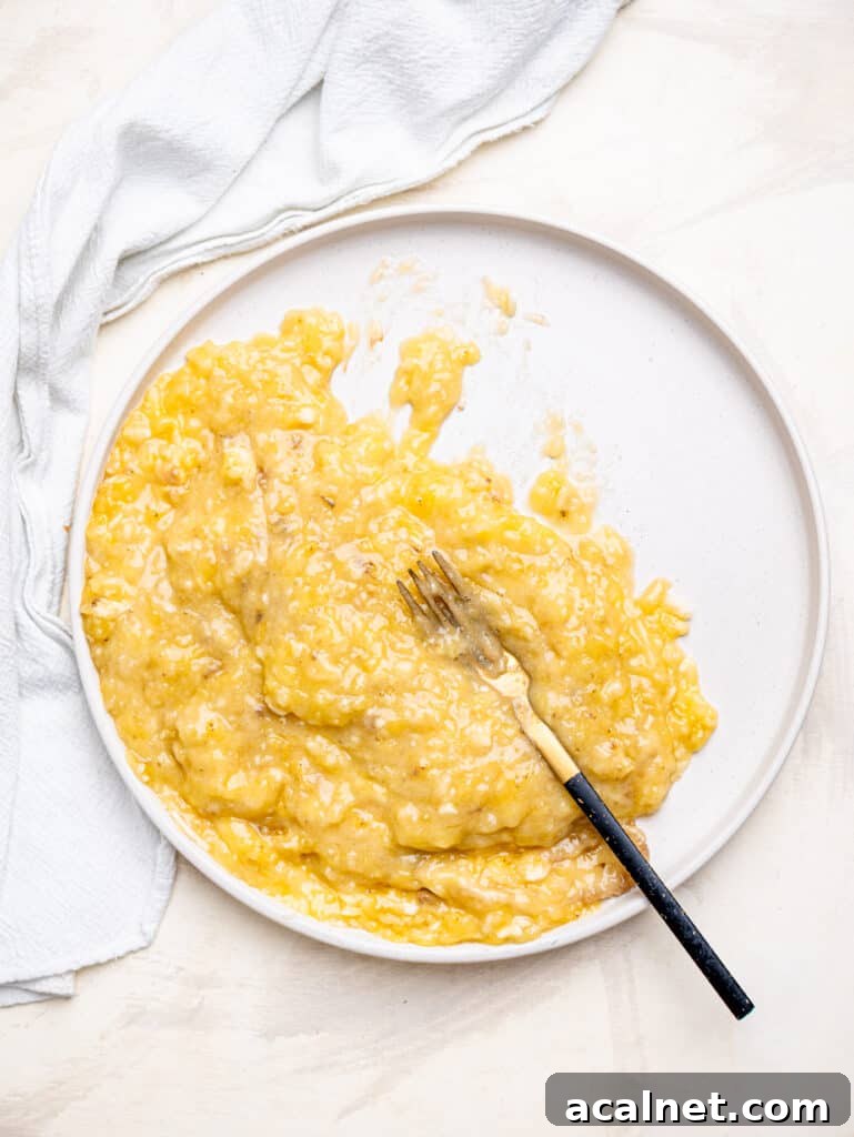 Mash bananas well for the best banana oatmeal muffins.