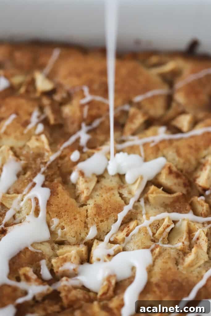 Glaze being drizzled over this Apple Coffee Cake recipe. 
