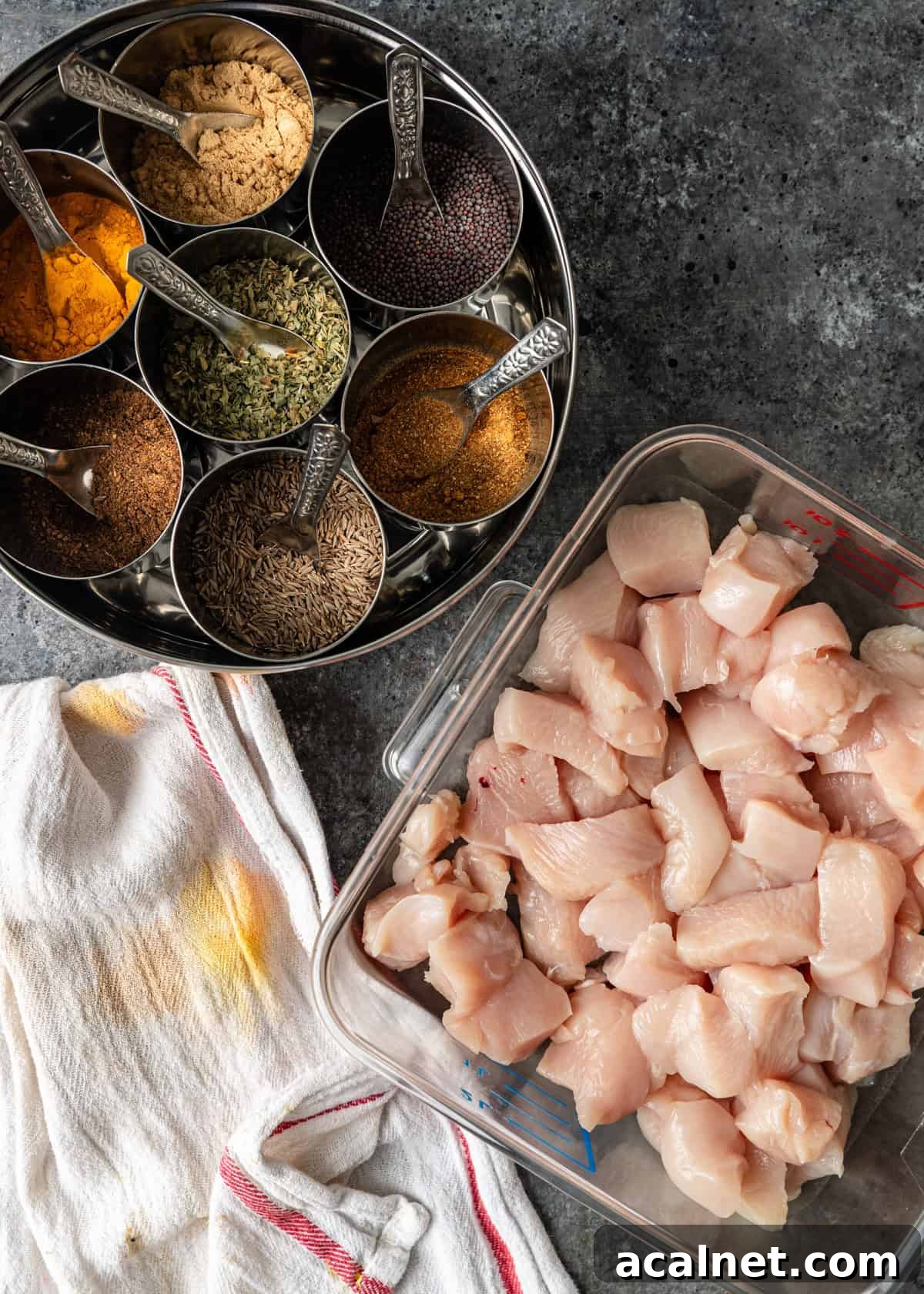 overhead process shot: dish of chicken pieces with bowls of seasonings
