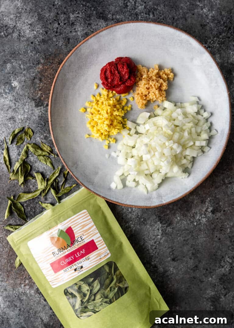overhead process shot: diced ingredients on plate with bag of curry leaves
