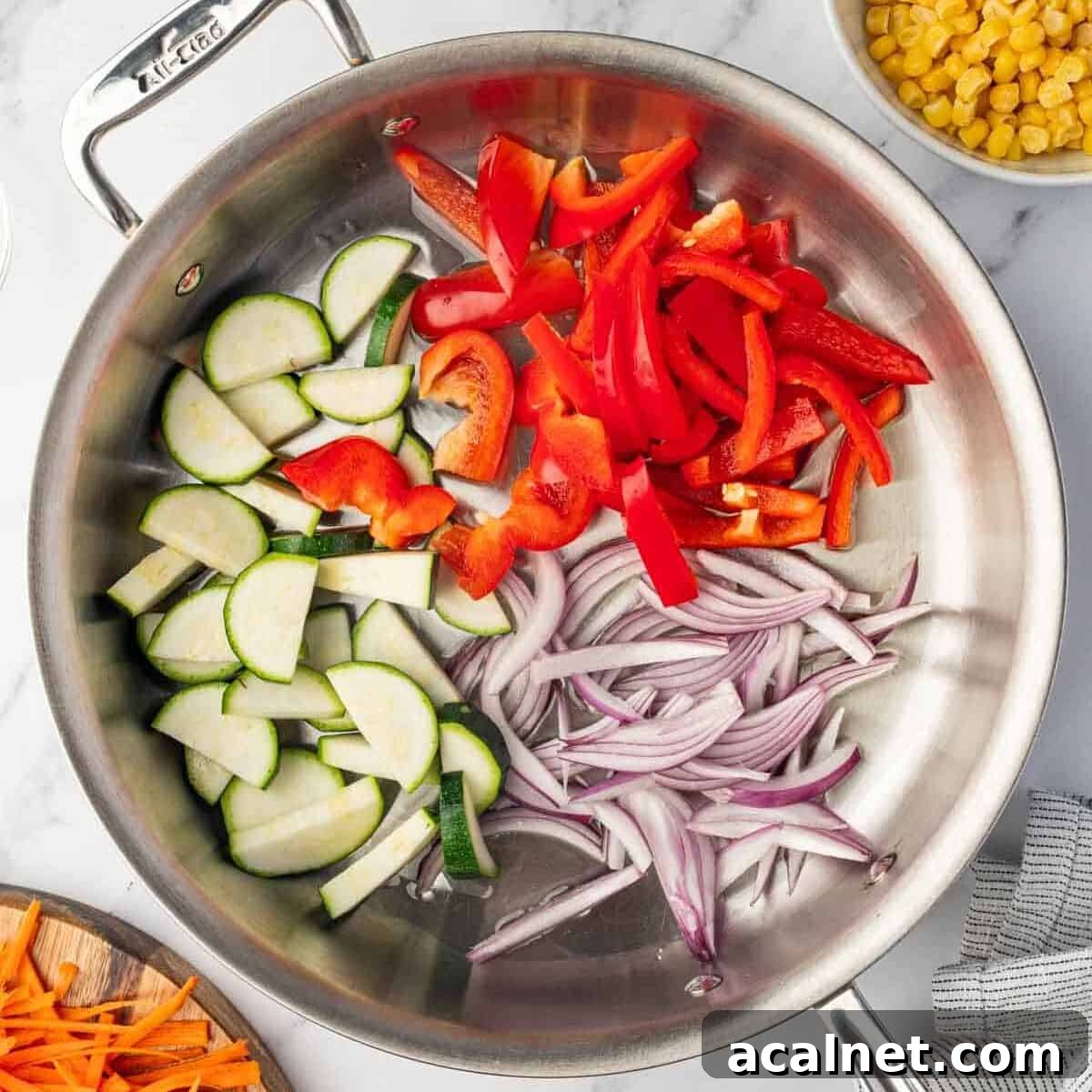 Chopped vegetables are added to a skillet to saute.