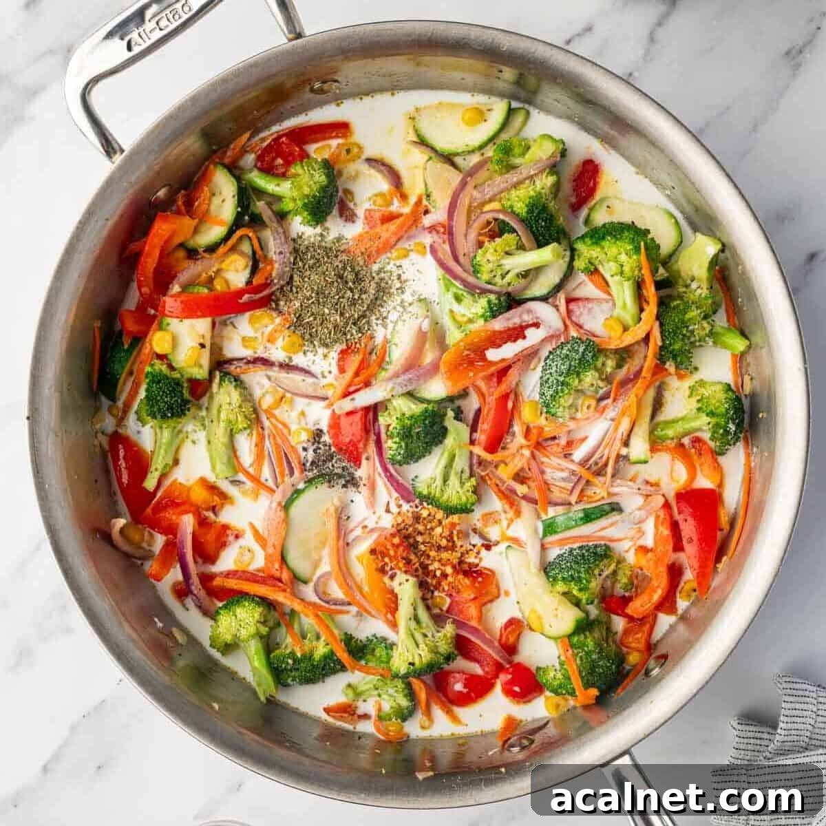 Seasonings are added to the creamy sauce blend.