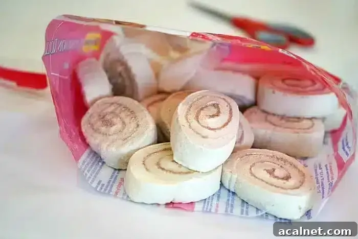 Open bag of packaged cinnamon swirl marshmallow snacks on a table, with scissors in the background—perfect for pairing with homemade monkey bread muffins.