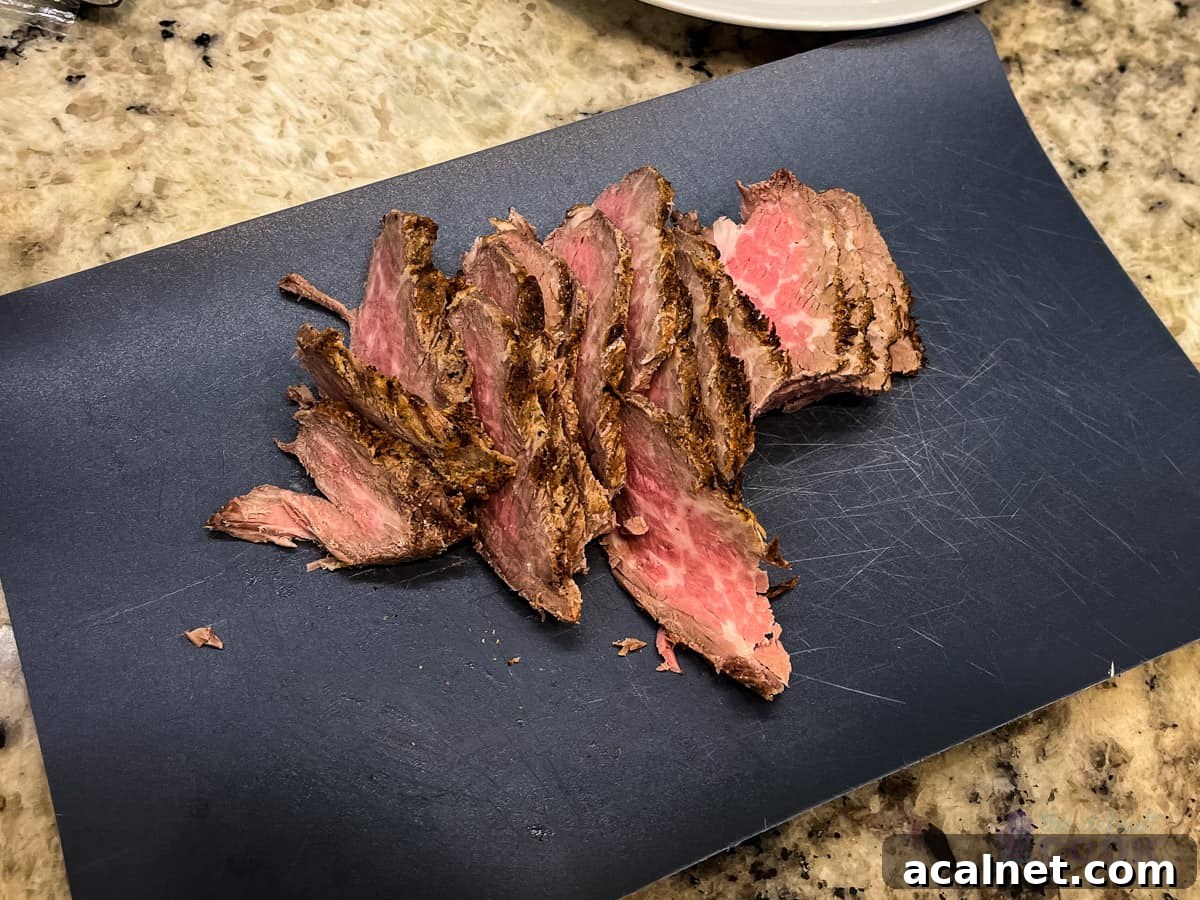 Ultimate Tri-Tip Sandwich Recipe: Juicy Steak Sandwich Guide 4 Sliced tri tip on a flexible cutting board.