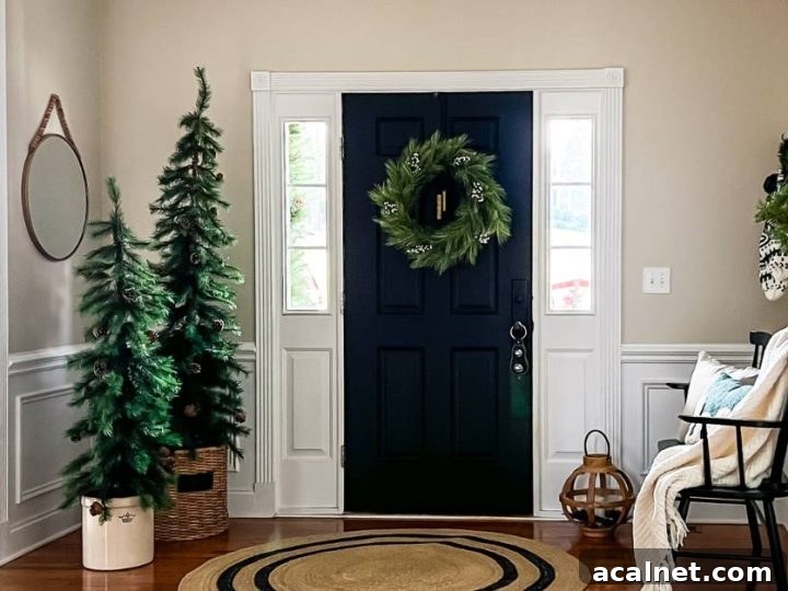 inside of home by front door with bench and small Christmas trees decorating the space