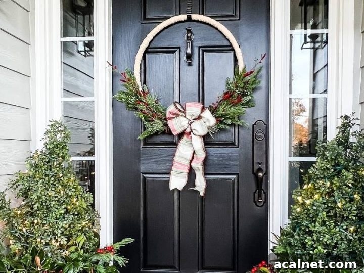 diy wreath made of yarn and greenery on front door