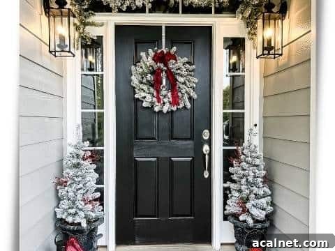 Black front door decorated for Christmas with King of Christmas 4-piece flocked set with red accents