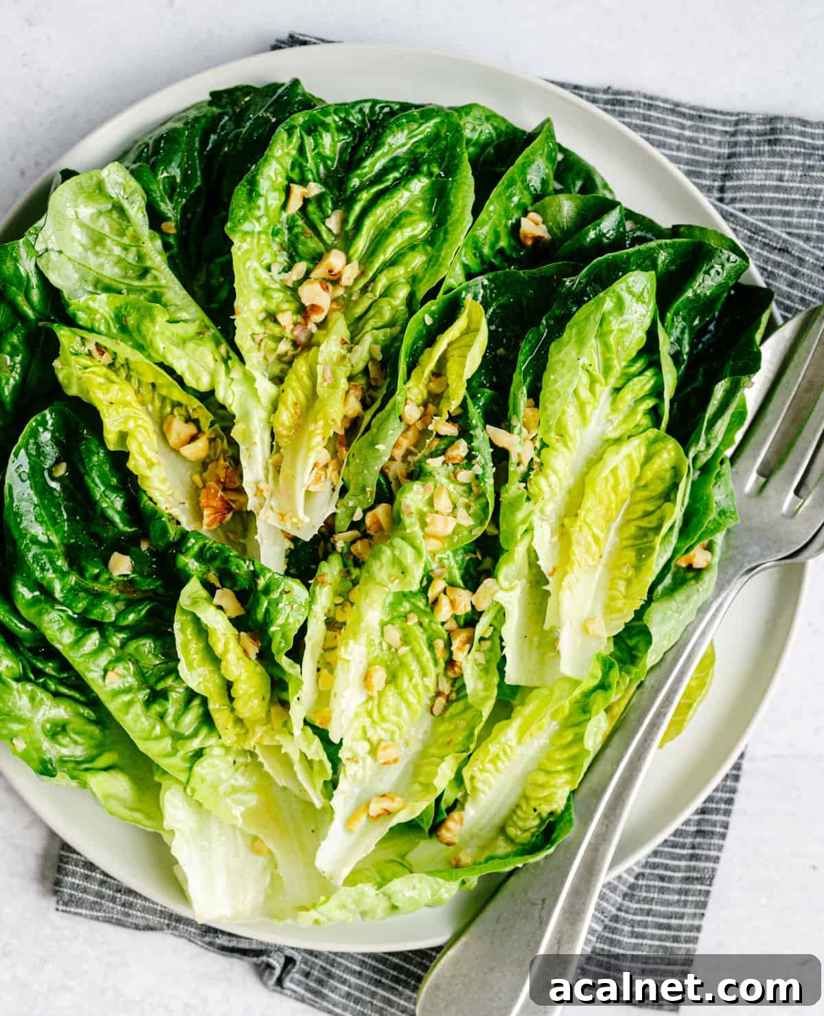 Little Gem Salad served on a round white platter and photographed from overhead.