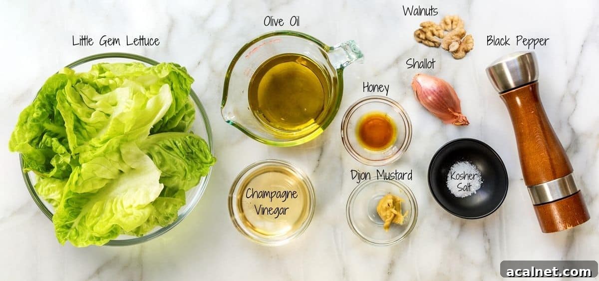 Little Gem Salad Ingredients on a white marble board.